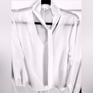 White long sleeve blouse with tie at neck. Fits M/L 8-10. Machine wash
